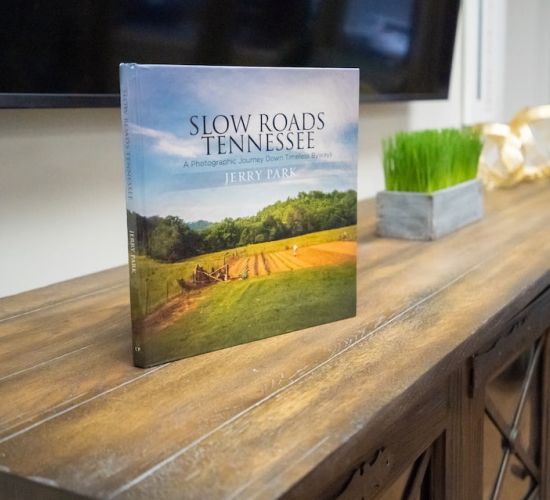 A book on shelf titled "Slow Roads in Tennessee"